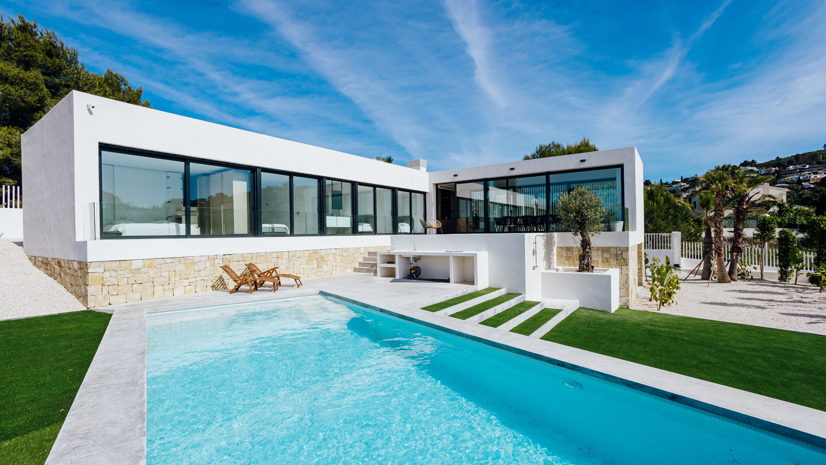 Children sitting by a pool in a luxury villa setting, calm family atmosphere